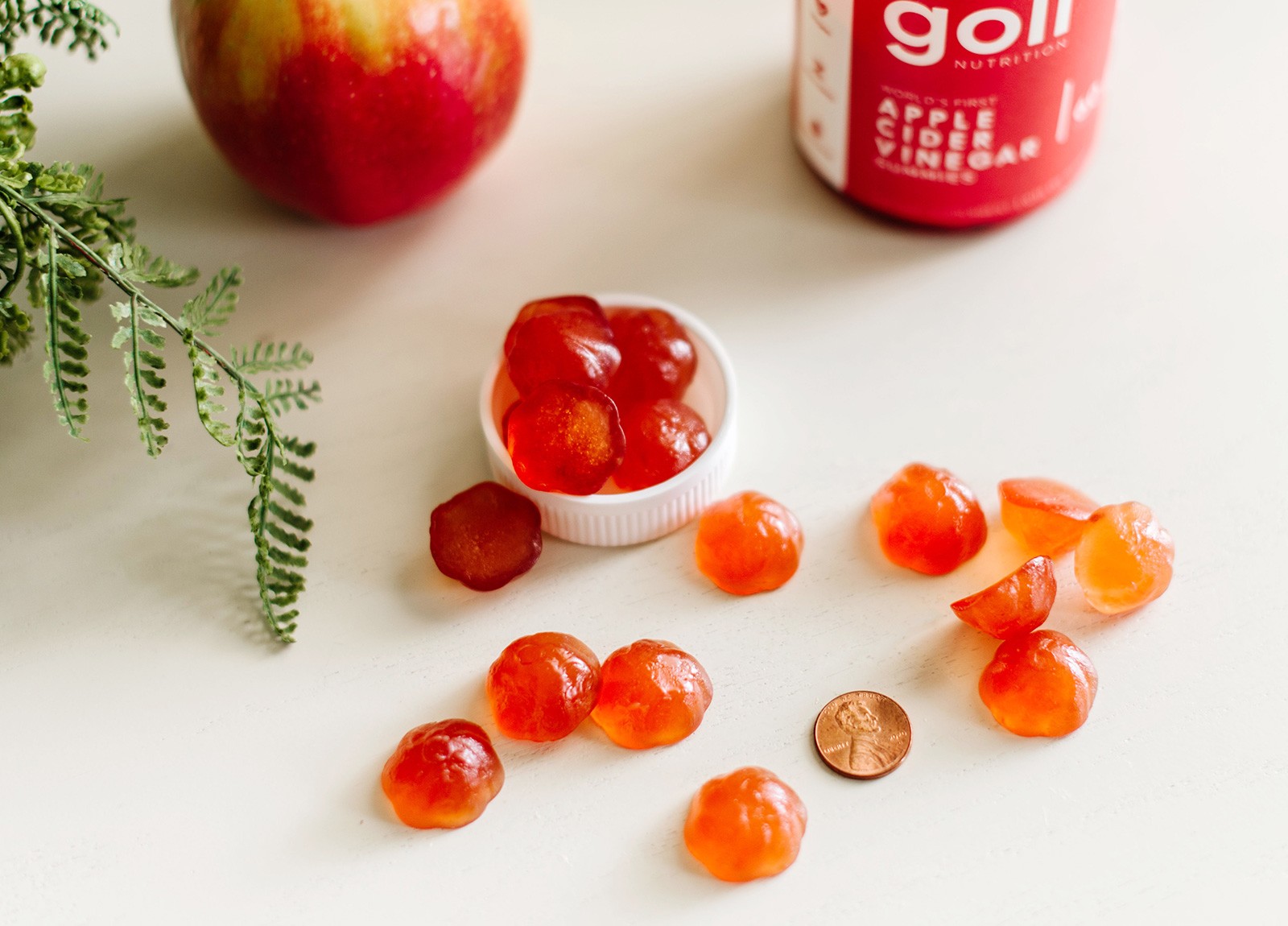 Goli ACV Gummies next to a penny