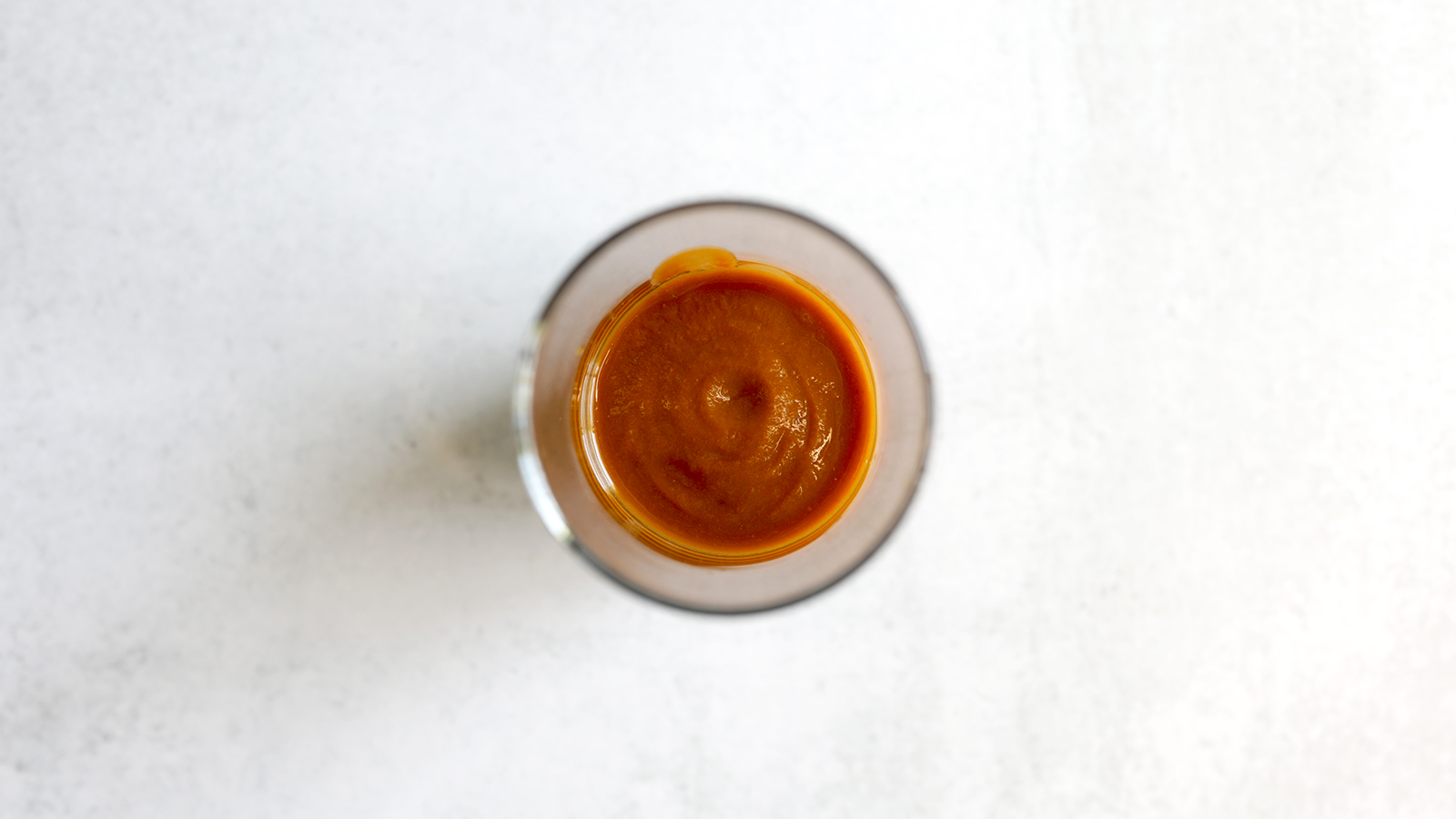 An upclose shot from above of SaladPower’s light brown purée in a glass.